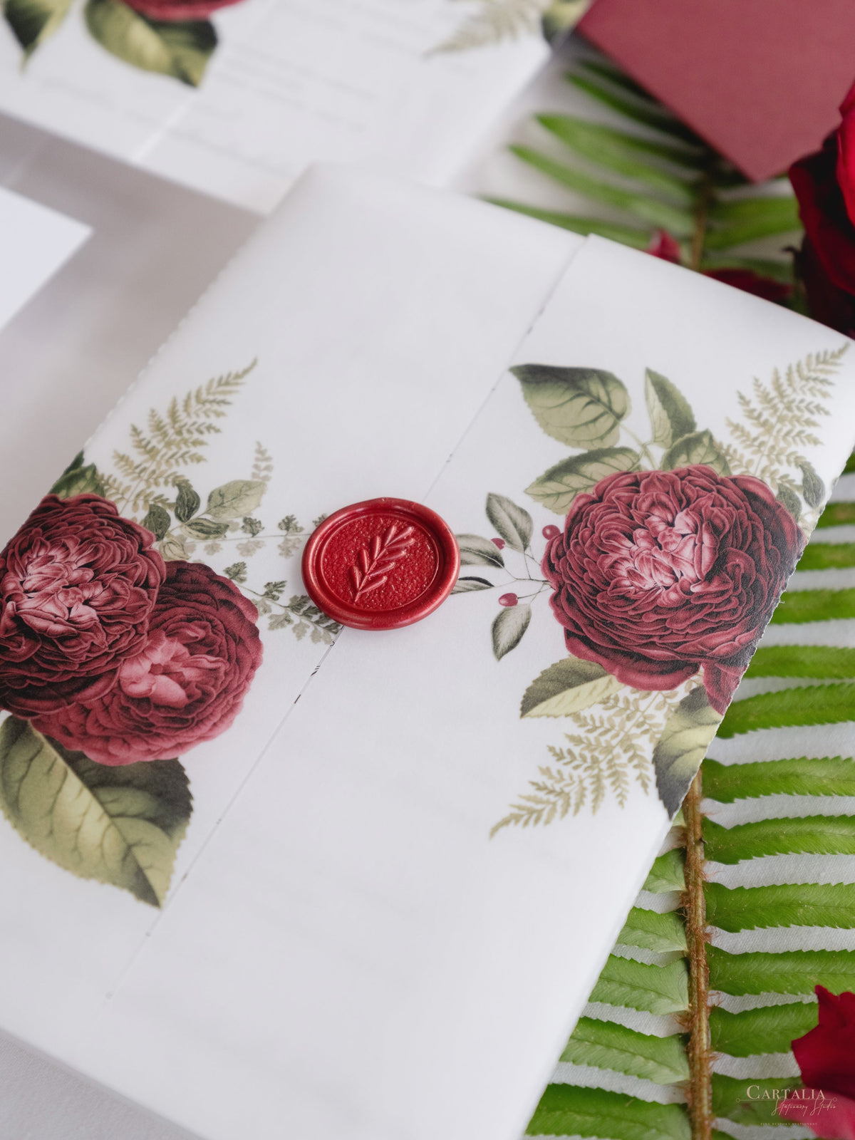 Modern Calligraphy Vellum Parchment Sleeve Invitation with Deep Red Floral Accents and Bordeaux Wax Seal